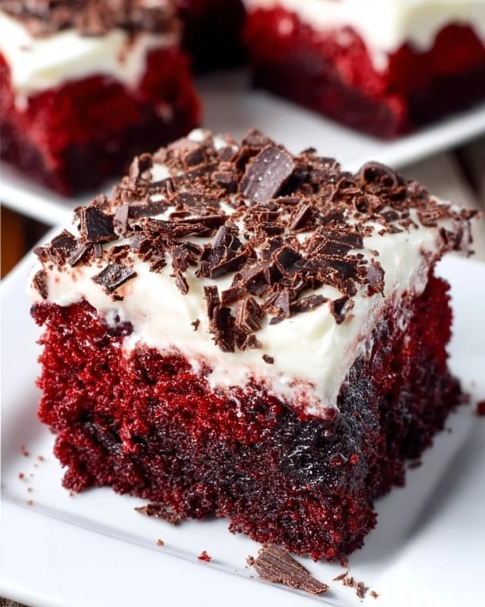 Slice of Brownie Bottom Red Velvet Cake showcasing rich layers and vibrant color