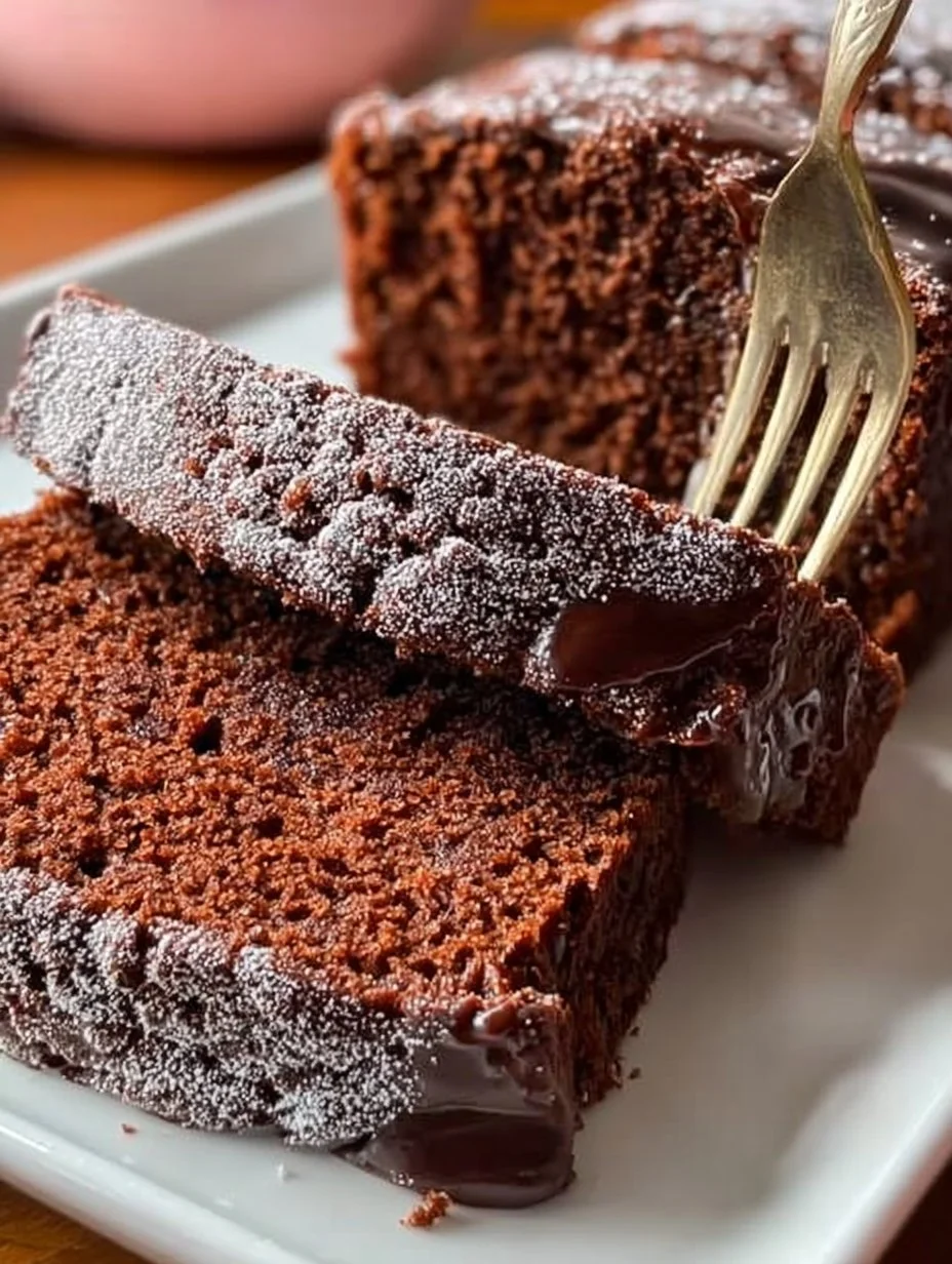 Deliciously rich Chocolate Pound Cake slice on a plate garnished with chocolate shavings.