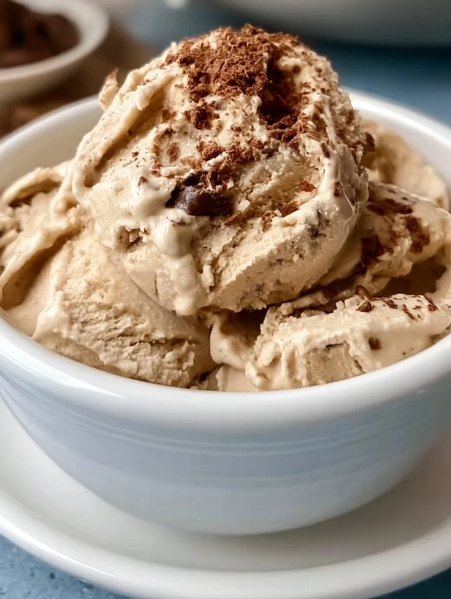 Bowl of easy no churn coffee ice cream served with coffee beans