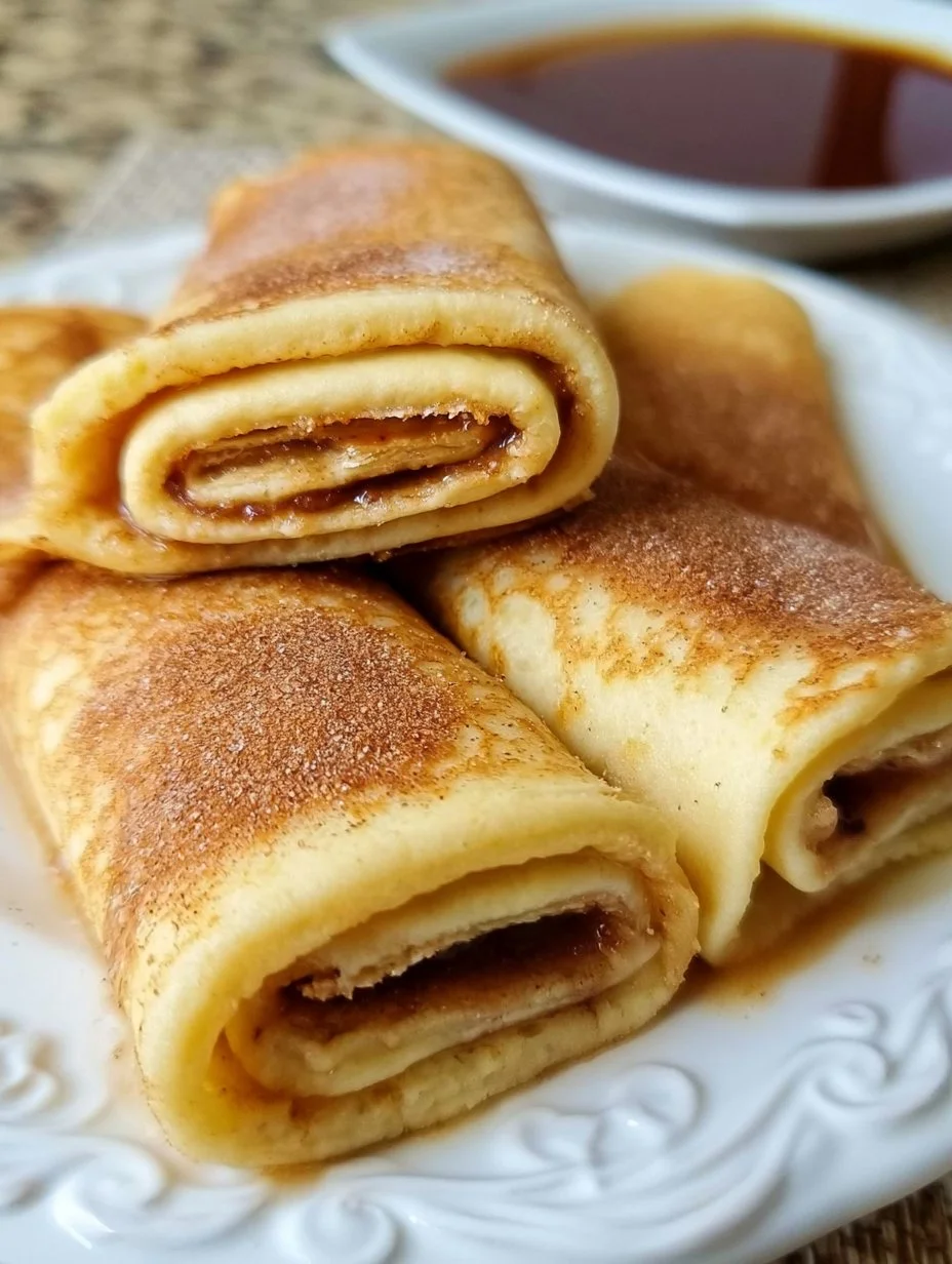 Delicious pancake rolls served with syrup and fruit toppings
