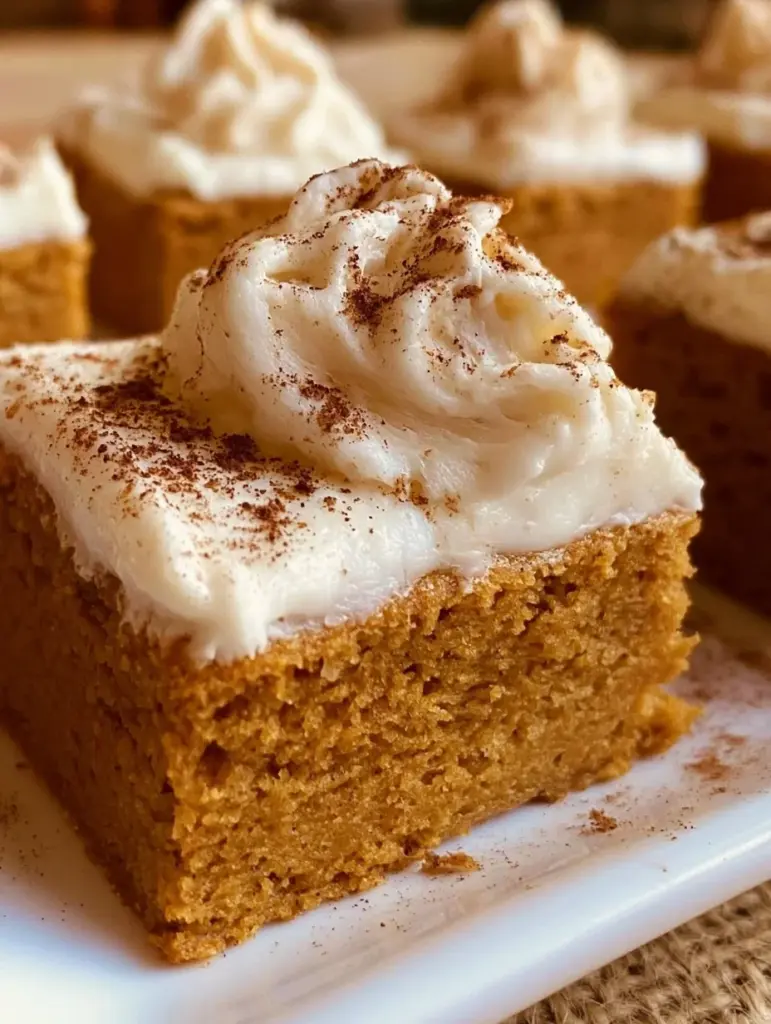 Delicious sourdough pumpkin bars topped with creamy frosting and walnuts